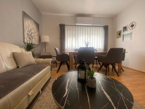 a living room with a couch and a table at Guesthouse EL in Ogulin