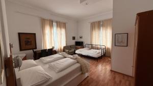 a bedroom with a bed and a living room at Hotel Stadtpark in Vienna