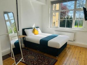 a bedroom with a bed and a mirror in it at Endsleigh Park Hotel in Hull