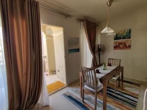 a dining room with a table and a door to a bathroom at veranda sahl hasheesh in Hurghada
