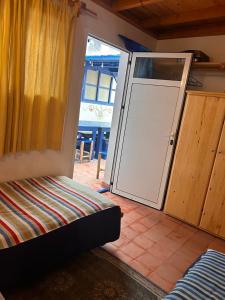 a room with a sliding glass door with a door at Tigmi Blue - Imsouane Surf et Océan in Imsouane +144 photos