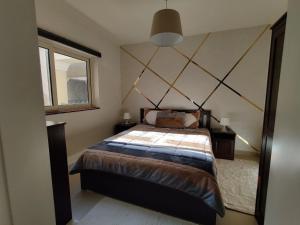 a bedroom with a large bed and a window at veranda sahl hasheesh in Hurghada