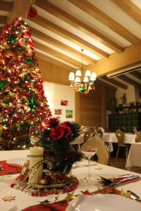 a christmas tree on a table in a restaurant at Hotel Heiderhof in Obersteinebach