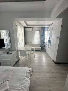 a bedroom with a bed and a table and chairs at Cicek Apart Hotel in Çeşme