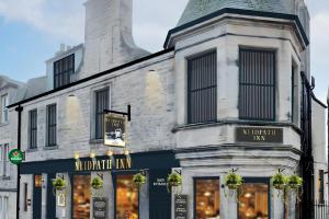 a building with a merchant inn on a street at Neidpath inn in Peebles