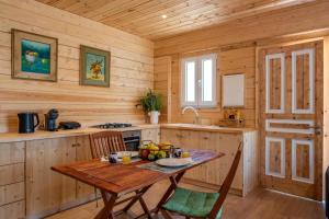a wooden kitchen with a wooden table in a cabin at Redon Marias House 1 in Ágios Matthaíos