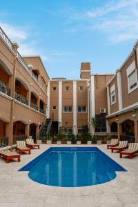 a pool in the courtyard of a apartment building at Solares Hotel & Spa in Alta Gracia +38 photos