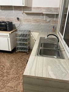 a kitchen with a sink and a counter top at Zahra Résidence in Rufisque +7 photos