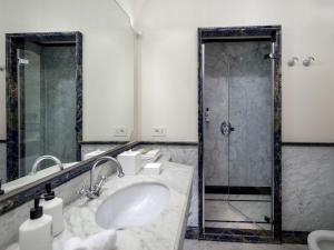 a bathroom with a sink and a shower at Hotel du Tasso Sorrento in Sorrento