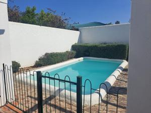 a swimming pool with a fence around it at De Kothuize 6 in Graaff-Reinet