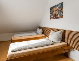 two beds in a room with a picture on the wall at Ferienwohnung Weigl Komfort in Nittenau