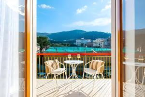 a balcony with a view of a table and chairs at Aranci 99 House in Sorrento
