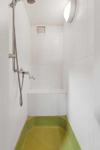 a green bath tub in a white bathroom with a shower at Erlaufsee Estate by Landluft in Mitterbach +48 photos
