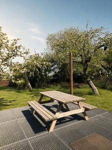 a wooden picnic table sitting on top of a grate at Ferienhaus Wacholder in Mechernich