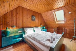 a bedroom with a bed in a wooden room at Erlaufsee Estate by Landluft in Mitterbach