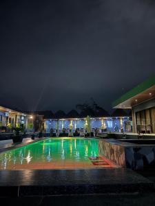 a pool in the middle of a building at night at DE PORCH in Bolinao