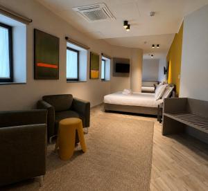 a living room with a bed and a couch at Best Quality Hotel Politecnico in Turin