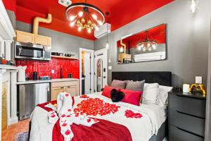 a bedroom with a red ceiling and a large bed at The West 142nd Street Apartments - Manhattan NYC in New York