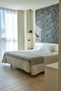 a bedroom with a large bed and a large window at Hotel Bilbao Plaza in Bilbao