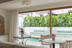 a living room with a couch and tables at Coral Beach Aparthotel in Marbella