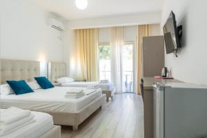 a hotel room with two beds and a television at Le Monde 2 in Borsh +35 photos