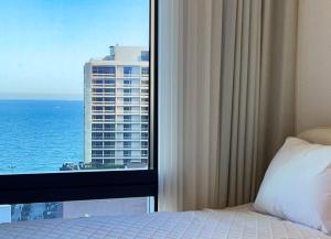 a bedroom with a window with a view of the ocean at Stay in WAVE in Ch'ŏngsap'o