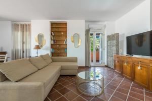 a living room with a couch and a table at Villa Thalissa by Perle di Puglia in Taranto