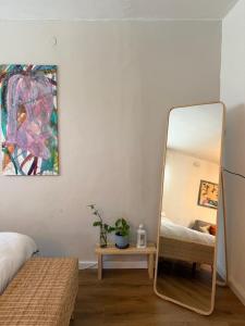 a mirror in a bedroom next to a bed at צימרים בצפון - אדם אדמה in Sheʼar Yashuv