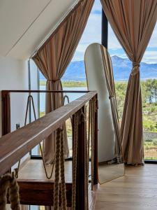 a room with a view of the mountains through windows at Lakeside Villas & Jacuzzi Suites in Shirokë