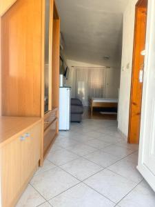 a kitchen with a white refrigerator and a room at MAAR Kovačić Apartmani in Zaton +10 photos