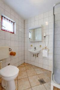 a bathroom with a toilet and a sink at MAAR Kovačić Apartmani in Zaton