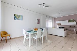 a dining room and living room with a table and chairs at Aranci 99 House in Sorrento