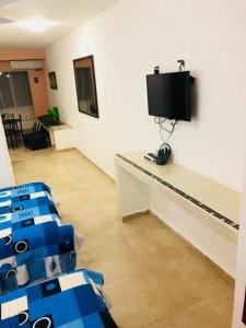 a room with chairs and a tv on a wall at CONDO Marena 2 in Playa del Carmen