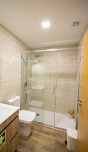 a bathroom with a shower and a toilet at As Casas do Penedo da Moura in Arcos de Valdevez +33 photos