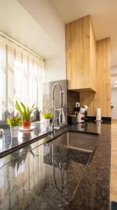 a kitchen with a sink and a counter top at As Casas do Penedo da Moura in Arcos de Valdevez