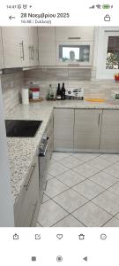 a kitchen with white cabinets and a counter top at aggelos home in Kato Alepochori