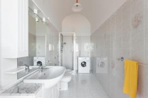 a white bathroom with a sink and a toilet at La casa del sole in Conca dei Marini +44 photos