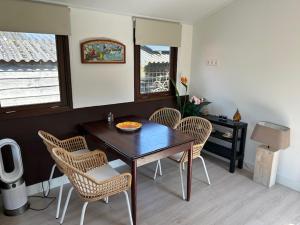 a dining room with a wooden table and chairs at De oude stal in Sleen
