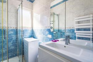 a bathroom with a sink and a toilet and a mirror at Mer Vue Sublime in Canet-en-Roussillon +19 photos