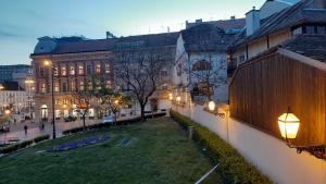 a city street with buildings and street lights at night at Apartment History in Zagreb