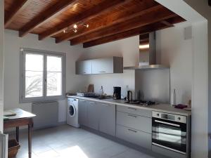 a kitchen with a stove and a dishwasher at Gîte Du Mas De La Font in Meyrueis