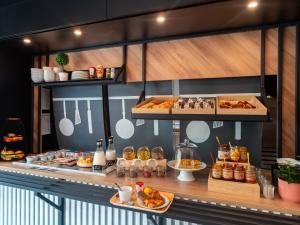 a buffet line with various pastries and other foods at B&B HOTEL Concarneau Keriolet in Concarneau