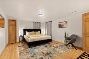 a bedroom with a bed and a chair at Elegant Manhattan Duplex in Manhattan