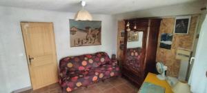 a living room with a couch and a door at Lou Mazet - Entre Vignes et Garrigue in Valflaunès