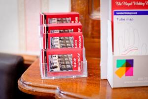 a group of cell phones sitting on top of a table at Avonmore Hotel in London