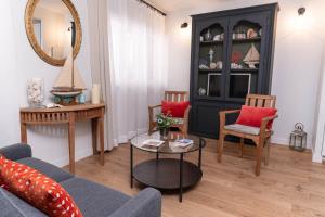 a living room with a couch and chairs and a mirror at Les Petits Volets Appartements à 100m de la mer in Antibes