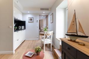 a kitchen and dining room with a sail boat on a table at Les Petits Volets Appartements à 100m de la mer in Antibes