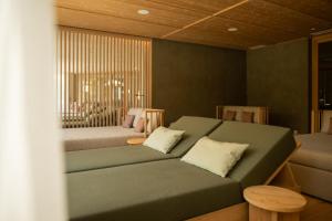 a bedroom with a couch and a bed in a room at Vitalpina Hotel Schulerhof in Plaus +52 photos
