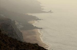 a view of the ocean and a beach on a cliff at Ait Mouli Agdal Retreat in Douar Debra