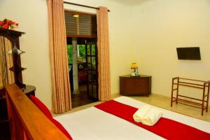 a bedroom with a bed and a large window at Hamilton View in Negombo